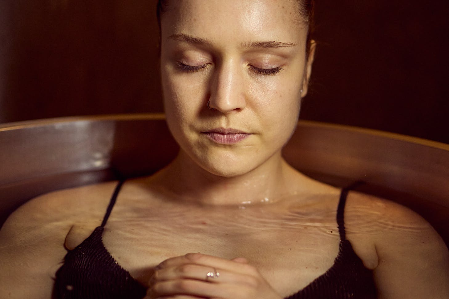 A woman sits in a zen state in an ice bath at Mode.